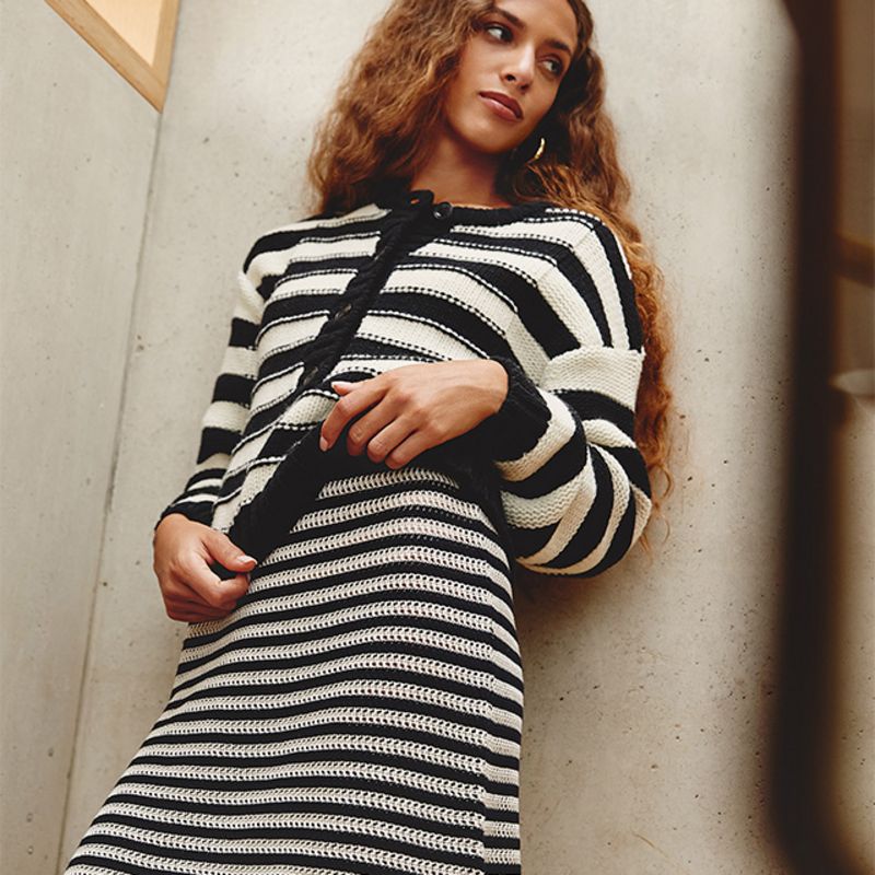Model wearing grey and navy lace sweater by Acne Studios