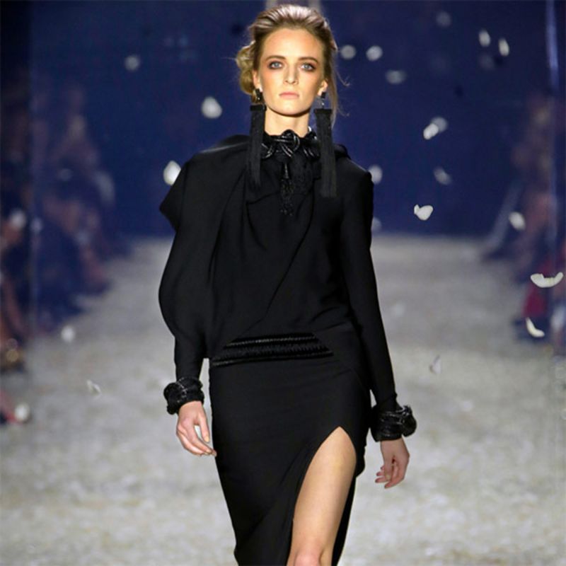 Model wearing black long sleeve dress by Tom Ford