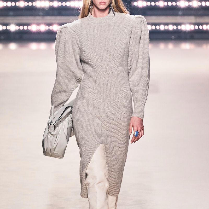 Model wearing checked coat, grey cardigan and red patent skirt by Isabel Marant