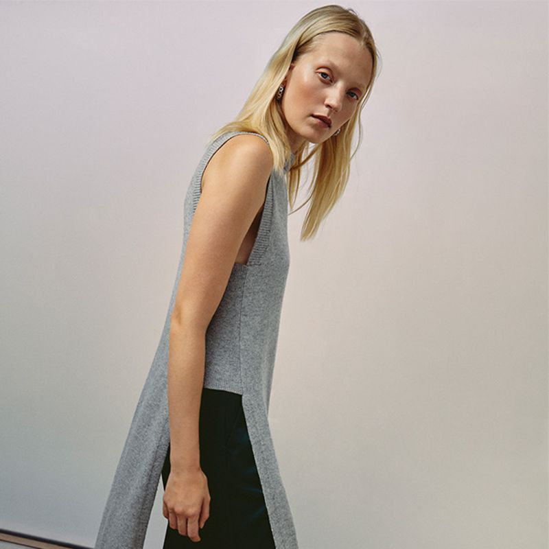 Model wearing grey plaid blanket coat by T by Alexander Wang