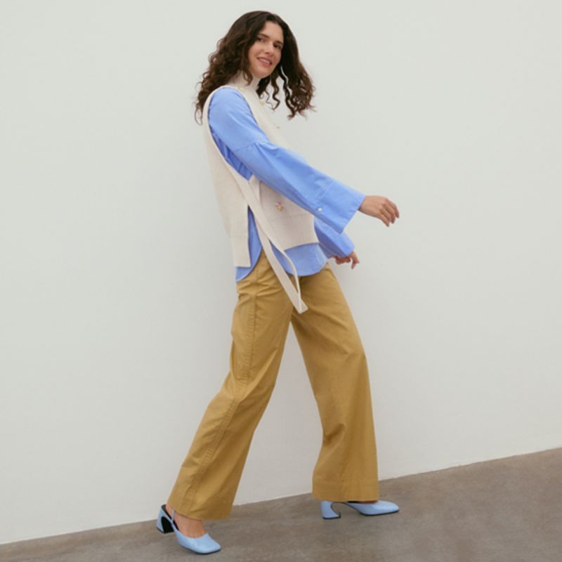 Model wearing white coat with floral embroidery by 3.1 Phillip Lim