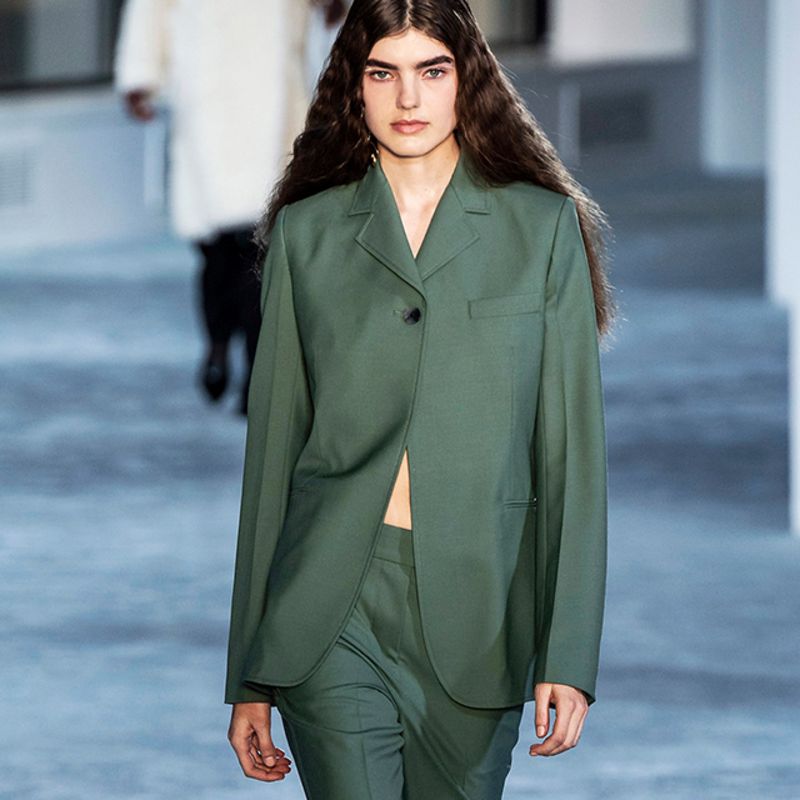 Model wearing white coat with floral embroidery by 3.1 Phillip Lim