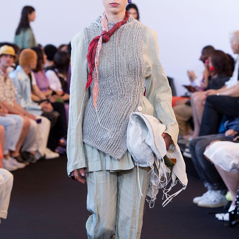 Model wearing blue printed denim jacket and pants by Acne Studios