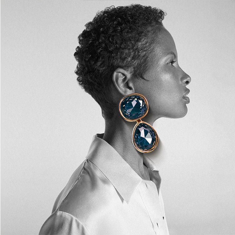 Model wearing sunglasses, jewellery and hat