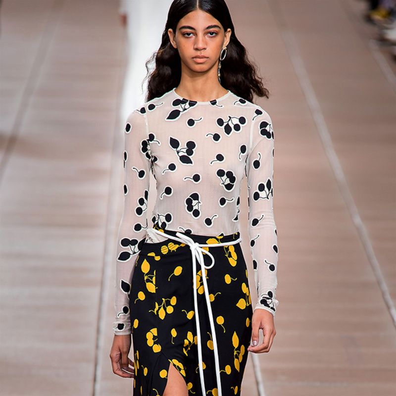 Model wearing white coat with floral embroidery by 3.1 Phillip Lim
