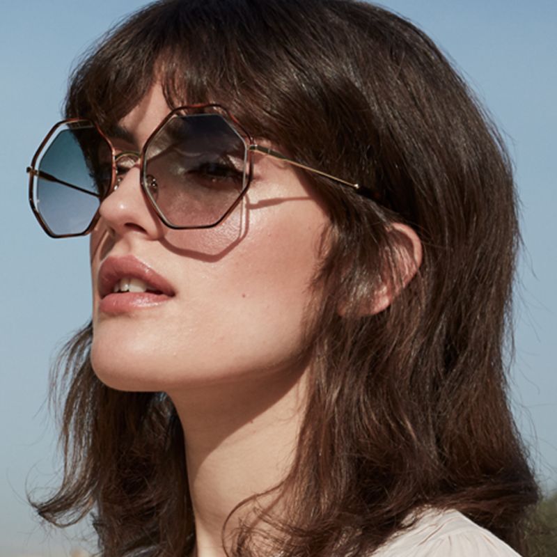 Model wearing round sunglasses by Jimmy Choo