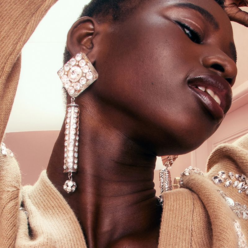 Model wearing sunglasses, jewellery and hat