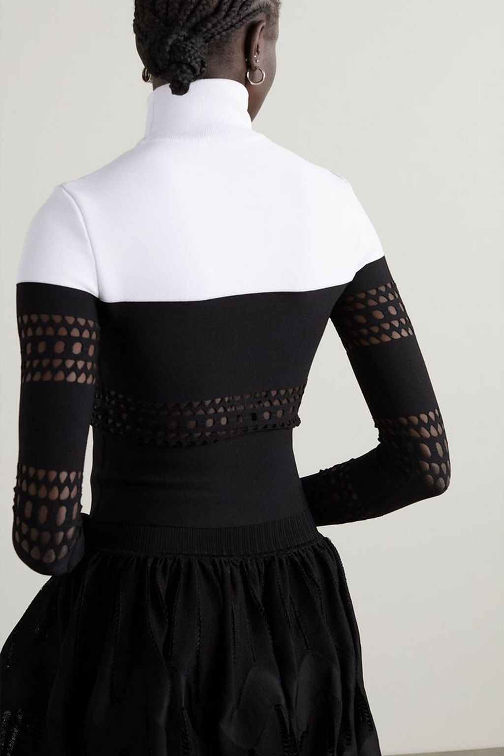 ALAÏA Two-tone laser-cut stretch-knit turtleneck top