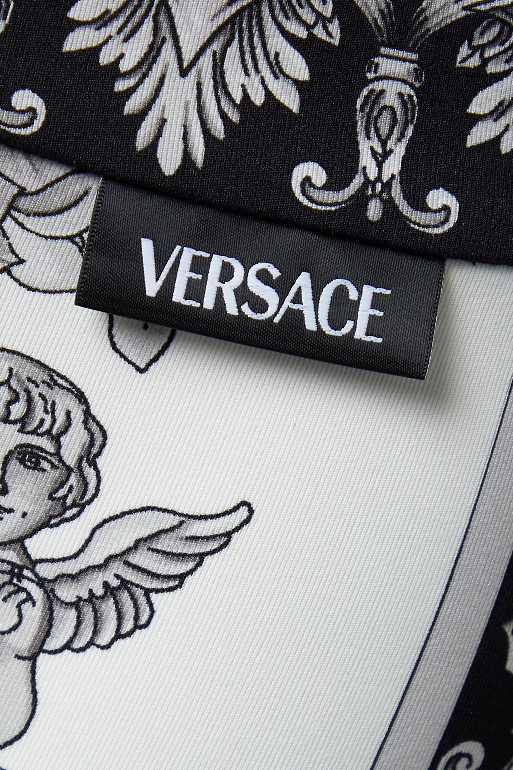 VERSACE بنطال ضيق من جيرسي مطاط مزين بطبعات