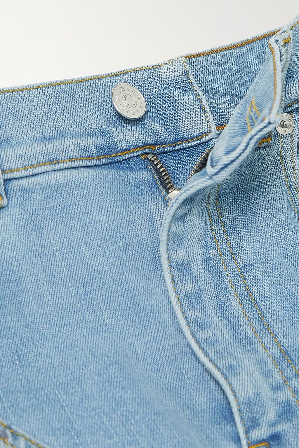 MUGLER بنطال جينز بأرجل ضيقة وخصرٍ عالٍ مع قطعٍ من الجيرسي المطاط