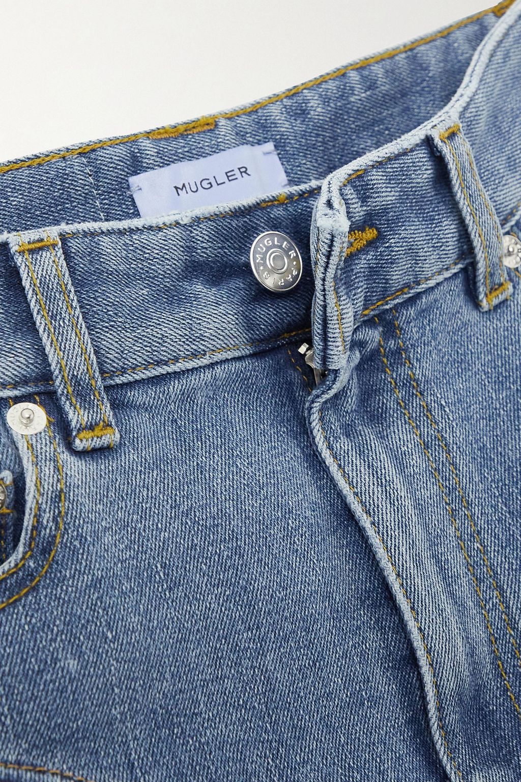 MUGLER بنطال جينز بأرجل ضيّقة وخصر عالٍ من قطع مُحاكة من الدنيم والدانتيل