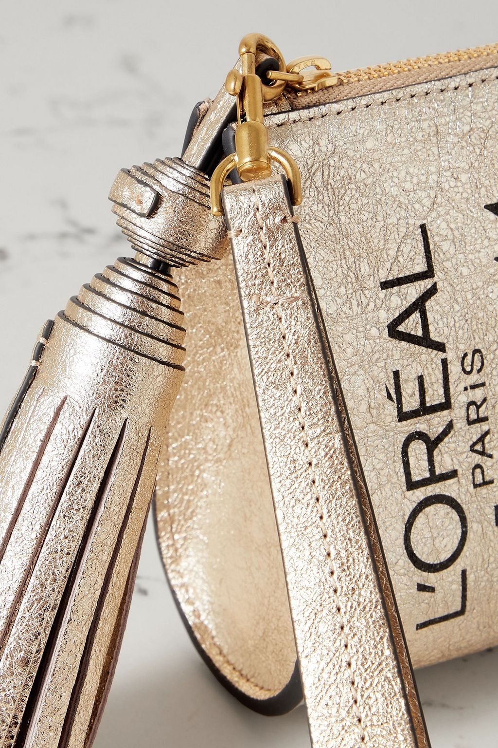 ANYA HINDMARCH Elnett tasseled printed metallic crinkled-leather clutch