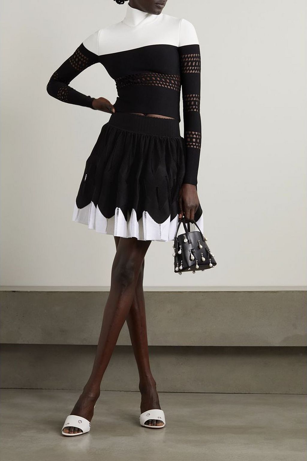 ALAÏA Two-tone pleated stretch-knit mini skirt