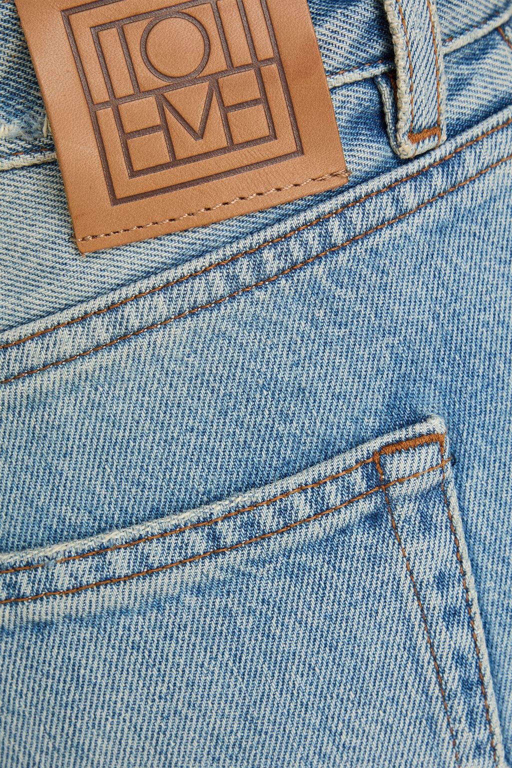 TOTEME Distressed high-rise tapered jeans